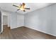 This bedroom features wood-look floors, a ceiling fan, and a closet at 1905 Emily Blvd, Winter Haven, FL 33884