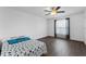 Bright bedroom features wood-look flooring, a ceiling fan, and a window with curtains at 1905 Emily Blvd, Winter Haven, FL 33884