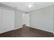 Neutral bedroom featuring vinyl flooring, closet, and a door leading to the hallway at 1905 Emily Blvd, Winter Haven, FL 33884