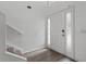 Bright foyer features wood-look flooring, staircase, and a door with sidelights at 1905 Emily Blvd, Winter Haven, FL 33884