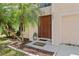 Inviting front entry featuring a meticulously landscaped yard, warm colors, and a welcome mat at 1905 Emily Blvd, Winter Haven, FL 33884