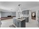 Open kitchen with gray cabinets, stainless steel sink, and view of the living room at 1905 Emily Blvd, Winter Haven, FL 33884