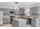 Stylish kitchen featuring gray cabinets, stainless steel appliances, and modern backsplash at 1905 Emily Blvd, Winter Haven, FL 33884