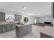 Open-concept kitchen with gray cabinets, stainless sink, and view to large backyard at 1905 Emily Blvd, Winter Haven, FL 33884