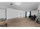 Bright living room featuring neutral carpet and view of the front door and staircase at 1905 Emily Blvd, Winter Haven, FL 33884