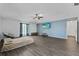 Spacious living room featuring wood-look floors, a ceiling fan, and ample natural light at 1905 Emily Blvd, Winter Haven, FL 33884