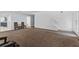 Open-concept living room with neutral carpet, and an entrance to the staircase at 1905 Emily Blvd, Winter Haven, FL 33884