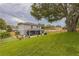 Expansive backyard featuring a screened lanai and lush landscaping, perfect for outdoor entertaining at 2032 Wavyleaf Ct, Apopka, FL 32712