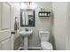 Bathroom featuring wood-look floors, new fixture, pedestal sink and toilet at 2032 Wavyleaf Ct, Apopka, FL 32712