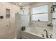Bathroom featuring a luxurious tub with decorative tile and an updated shower with glass door at 2032 Wavyleaf Ct, Apopka, FL 32712