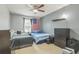 Bedroom with two beds, ceiling fan, and American flag accent; dresser and nightstand at 2032 Wavyleaf Ct, Apopka, FL 32712