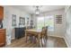 Cozy dining area with a wooden table set and natural light from the window at 2032 Wavyleaf Ct, Apopka, FL 32712