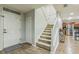 Bright foyer with hardwood floors leading to a staircase, and a view of the modern kitchen at 2032 Wavyleaf Ct, Apopka, FL 32712