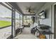 Spacious lanai featuring a comfortable seating area, television, grilling area and a view of the backyard at 2032 Wavyleaf Ct, Apopka, FL 32712