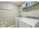 Laundry room equipped with a modern washer, dryer, and shelving for storage at 2032 Wavyleaf Ct, Apopka, FL 32712