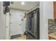 Practical mud room with a black refrigerator near the entryway at 2032 Wavyleaf Ct, Apopka, FL 32712