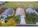 Aerial shot of a home showcasing its well-manicured front yard and convenient driveway at 207 Langham Dr, Davenport, FL 33897