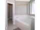 Corner bathtub and entrance to walk-in closet offer a spa-like bathroom at 207 Langham Dr, Davenport, FL 33897