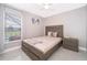 Serene bedroom featuring neutral color palette, tile floors, and outdoor views at 207 Langham Dr, Davenport, FL 33897