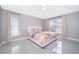 Bright bedroom with tile floors, two windows, and a light-colored comforter at 207 Langham Dr, Davenport, FL 33897