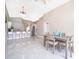 Bright dining area flows into kitchen with stylish chandelier and breakfast bar at 207 Langham Dr, Davenport, FL 33897