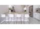 Well-equipped kitchen with granite countertops, stainless steel appliances, and seating at the bar at 207 Langham Dr, Davenport, FL 33897