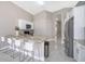 Modern kitchen with granite countertops, stainless steel appliances, and a breakfast bar with seating at 207 Langham Dr, Davenport, FL 33897