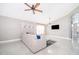 Bright living room offering a comfortable sectional sofa, stylish decor, and a view into the kitchen at 207 Langham Dr, Davenport, FL 33897