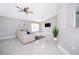 Inviting living room with modern decor, a plush sectional, and light-filled windows at 207 Langham Dr, Davenport, FL 33897