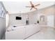 Spacious living area with neutral walls, tile flooring, and a view into the kitchen at 207 Langham Dr, Davenport, FL 33897