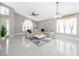 Comfortable living space with a plush sectional sofa, bright windows, and a stylish rug at 207 Langham Dr, Davenport, FL 33897
