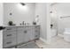 Bathroom with grey vanity, sleek countertop, and a view into the shower and commode room at 2300 S Brown Ave, Orlando, FL 32806