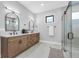 Modern bathroom with double vanity, sleek fixtures, and a glass-enclosed shower at 2300 S Brown Ave, Orlando, FL 32806