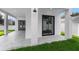 Covered patio with white columns, leading to a well-manicured backyard with lush green grass at 2300 S Brown Ave, Orlando, FL 32806