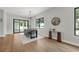 Bright dining room with hardwood floors, statement mirror, and black framed windows and sliding glass door at 2300 S Brown Ave, Orlando, FL 32806