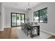 Elegant dining area featuring a modern chandelier, hardwood floors, and sliding glass doors to the outdoor space at 2300 S Brown Ave, Orlando, FL 32806