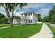 Beautiful two-story home featuring a well-manicured lawn, complementing the home's crisp, white exterior at 2300 S Brown Ave, Orlando, FL 32806