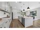 Bright, spacious kitchen with white cabinetry, an island with a waterfall countertop, and stainless steel appliances at 2300 S Brown Ave, Orlando, FL 32806
