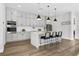 Modern kitchen featuring stainless steel appliances, a central island with barstool seating and white cabinetry at 2300 S Brown Ave, Orlando, FL 32806