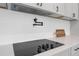 Close-up of the kitchen, with a pot filler and induction stove installed in a white countertop at 2300 S Brown Ave, Orlando, FL 32806