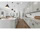 Modern kitchen featuring white cabinetry, a large island, and stainless steel appliances at 2300 S Brown Ave, Orlando, FL 32806