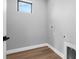 Bright laundry room with hardwood floors, a window, and hookups at 2300 S Brown Ave, Orlando, FL 32806