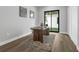 Well-lit home office with hardwood flooring, a rustic desk, and sliding glass door to the backyard at 2300 S Brown Ave, Orlando, FL 32806