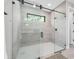 Modern bathroom featuring frameless glass shower enclosure with marble tile at 2300 S Brown Ave, Orlando, FL 32806