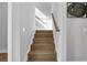 Modern stairway with light wood steps and a simple wooden handrail for an open and airy design at 2300 S Brown Ave, Orlando, FL 32806