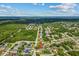 Aerial view of a quiet residential neighborhood surrounded by lush greenery and featuring a home with a pool at 2351 El Prado Ter, Deltona, FL 32725