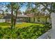 Lush backyard featuring a screened pool, green lawn, and a partial fence for added privacy at 2351 El Prado Ter, Deltona, FL 32725