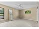 Neutral bedroom with tile floors features a large window at 2351 El Prado Ter, Deltona, FL 32725