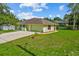 Well-maintained front yard showcasing the home's exterior, driveway, and manicured lawn at 2351 El Prado Ter, Deltona, FL 32725