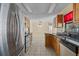 Modern kitchen with stainless steel appliances, wooden cabinets and dark countertops at 2351 El Prado Ter, Deltona, FL 32725